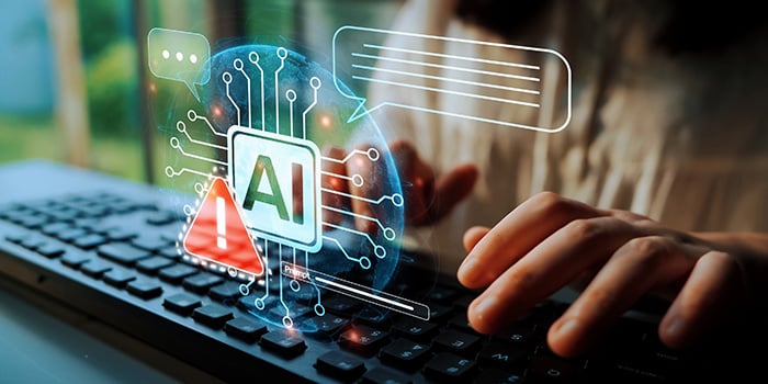 mains de femme sur clavier d'ordinateur portable avec un hologramme affichant le sigle AI et un triangle d'avertissement